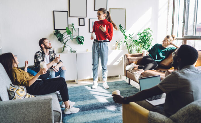 A group of work colleagues discussing corporate storytelling tactics in a relaxed environment