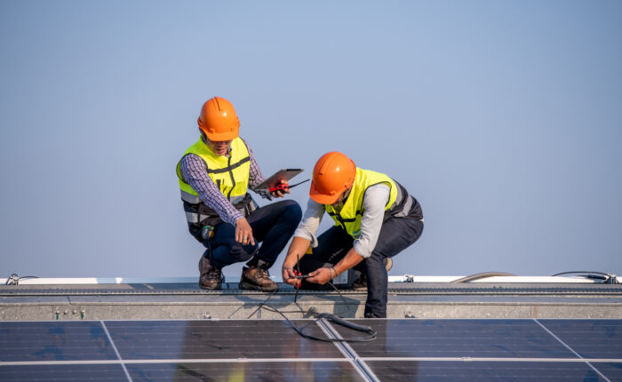 Workforce Apprentice in training fitting solar pannels